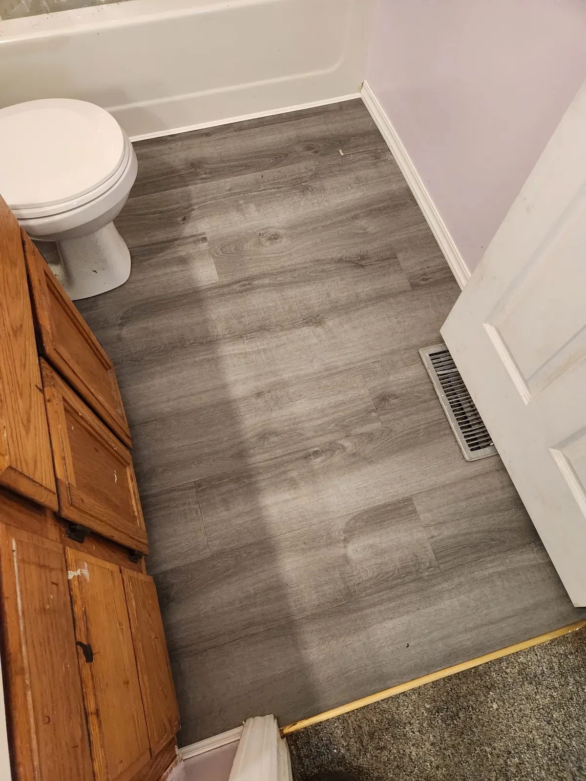 New vinyl plank flooring installed in a Milwaukee bathroom