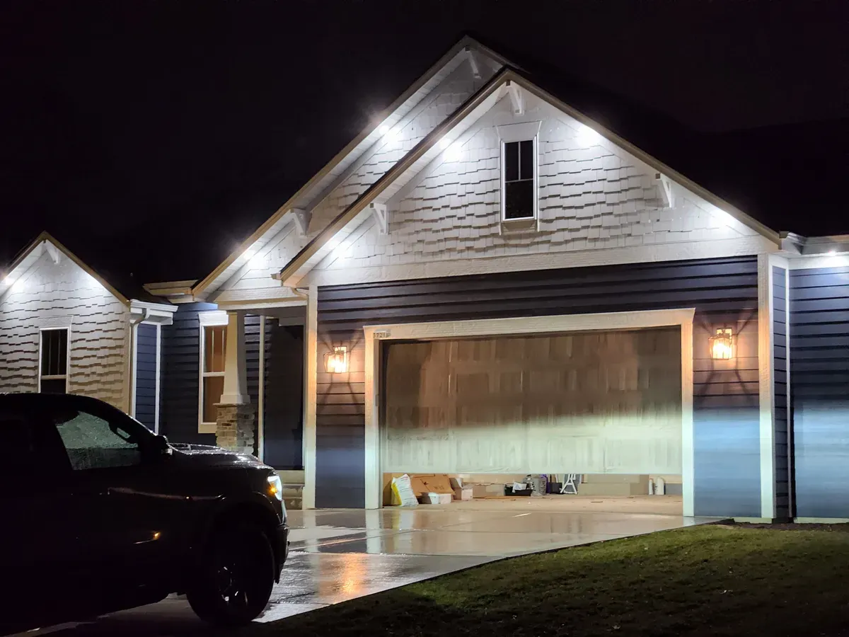 New outdoor porch lights installed on a Milwaukee home at night